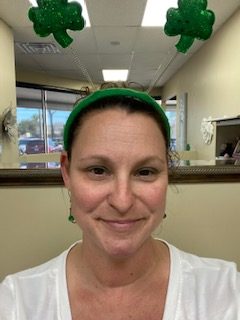 Face of person, Melani Rocheleau, wearing a shamrock hat