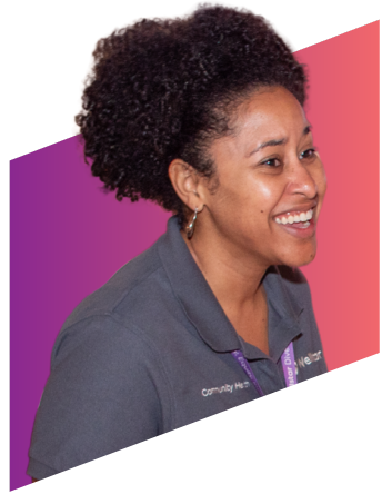 smiling woman wearing a lanyard working at a booth at a festival