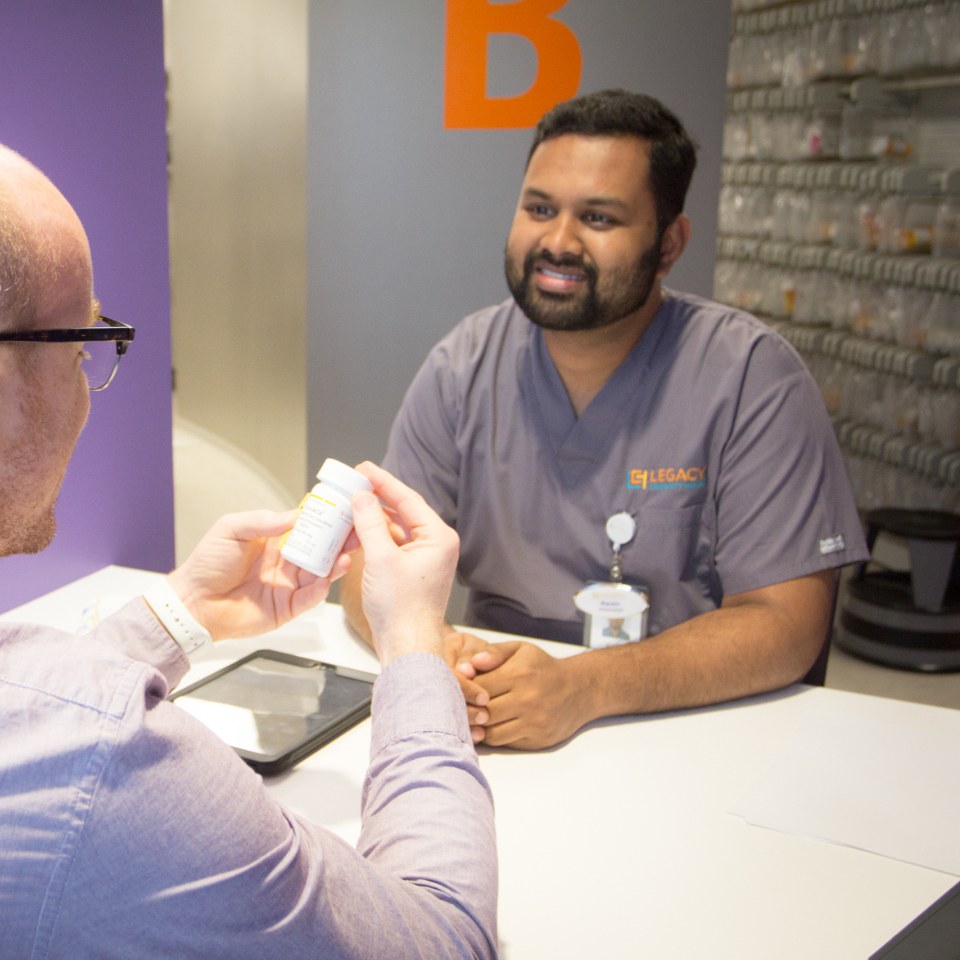 Kevin, pharmacist, helping a patient with a medication