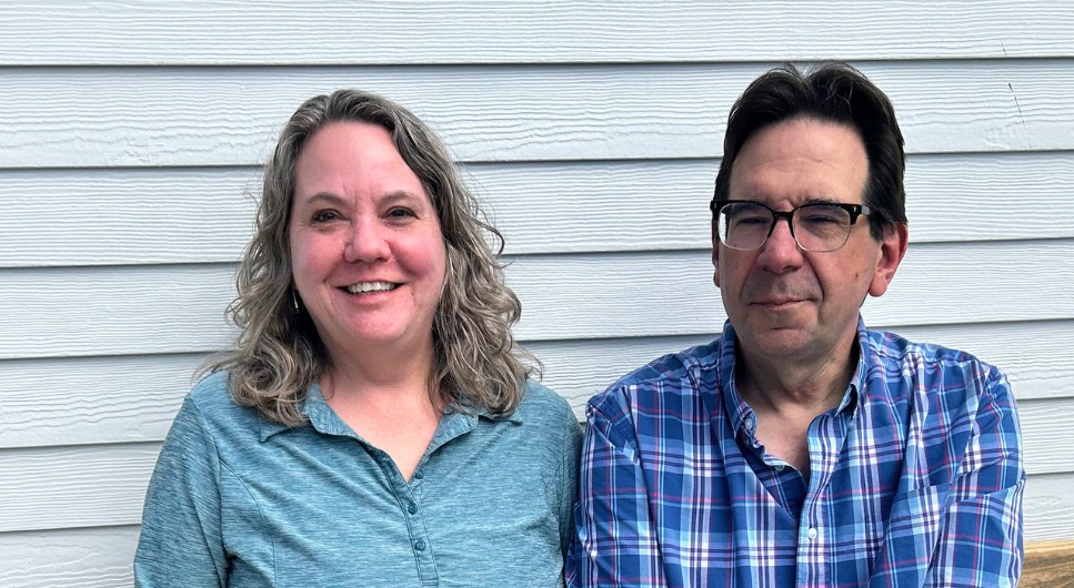 Denise seated next to her husband